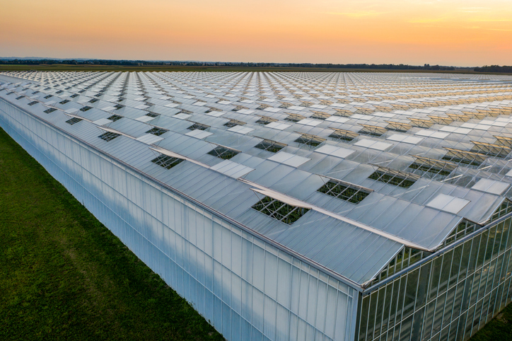 How can a system with a controlled environment help improve crop performance?